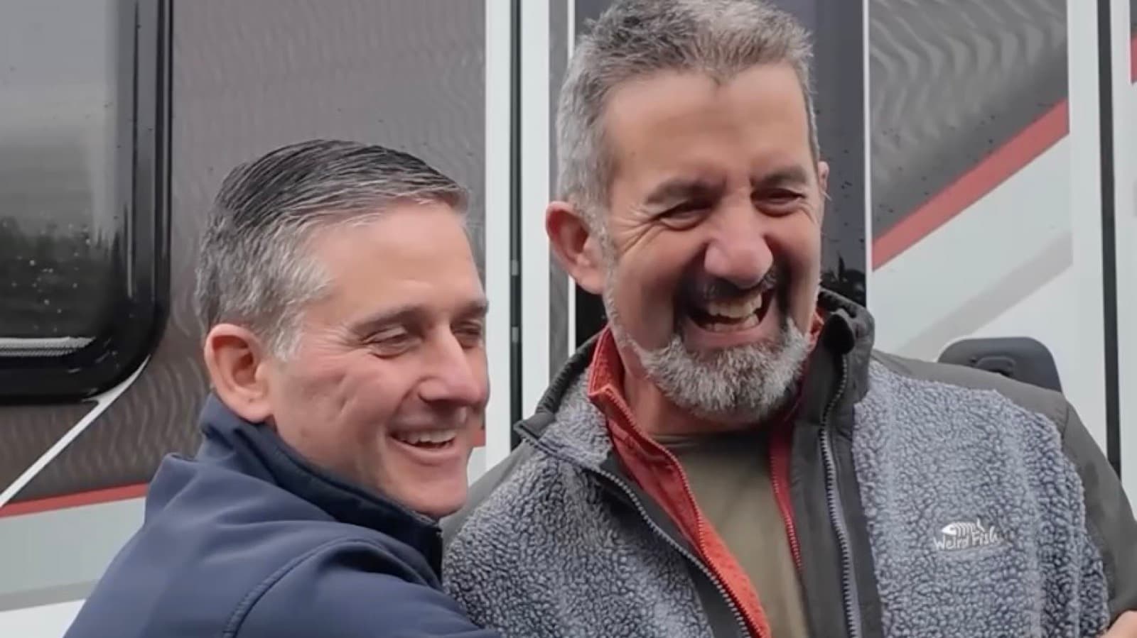 Gary Cheetham, founder of Motorhome Pig, laughing with a customer beside his motorhome after the sale
